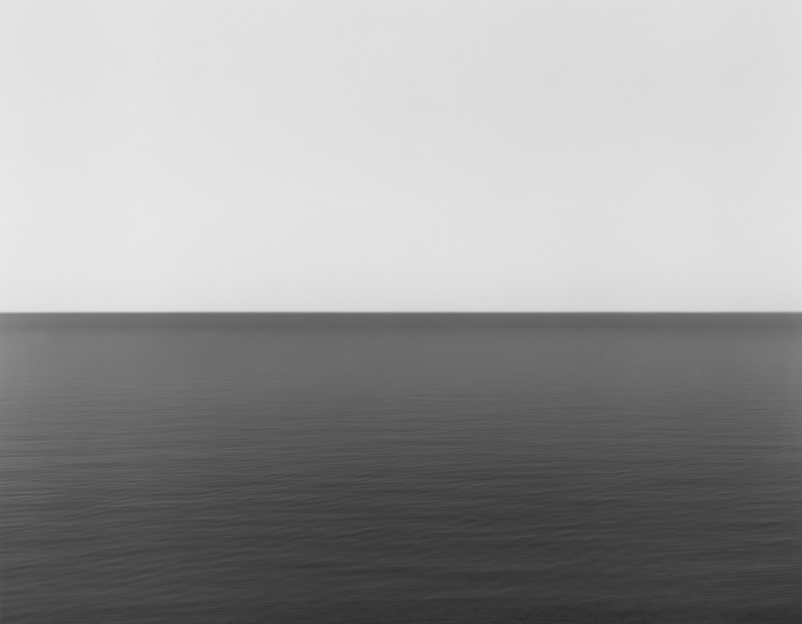 Black and white photograph of the horizon with equal parts sky and sea