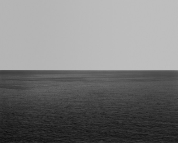 Black and white photograph of the horizon with equal parts sky and sea