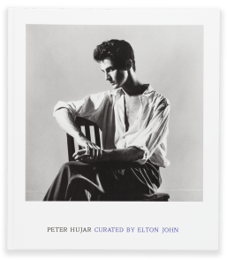 Color image of book cover with black and white photograph of seated man with partially buttoned white shirt